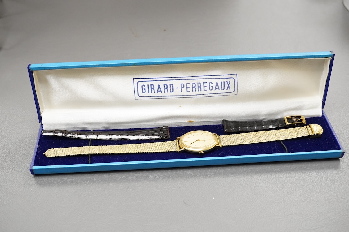 A gentleman's 18ct Girard-Perregaux manual wristwatch, oval brushed gilt dial with raised hour baton marks, seventeen jewels movement, signed, on an associated gilt metal articulated bracelet, in original case.